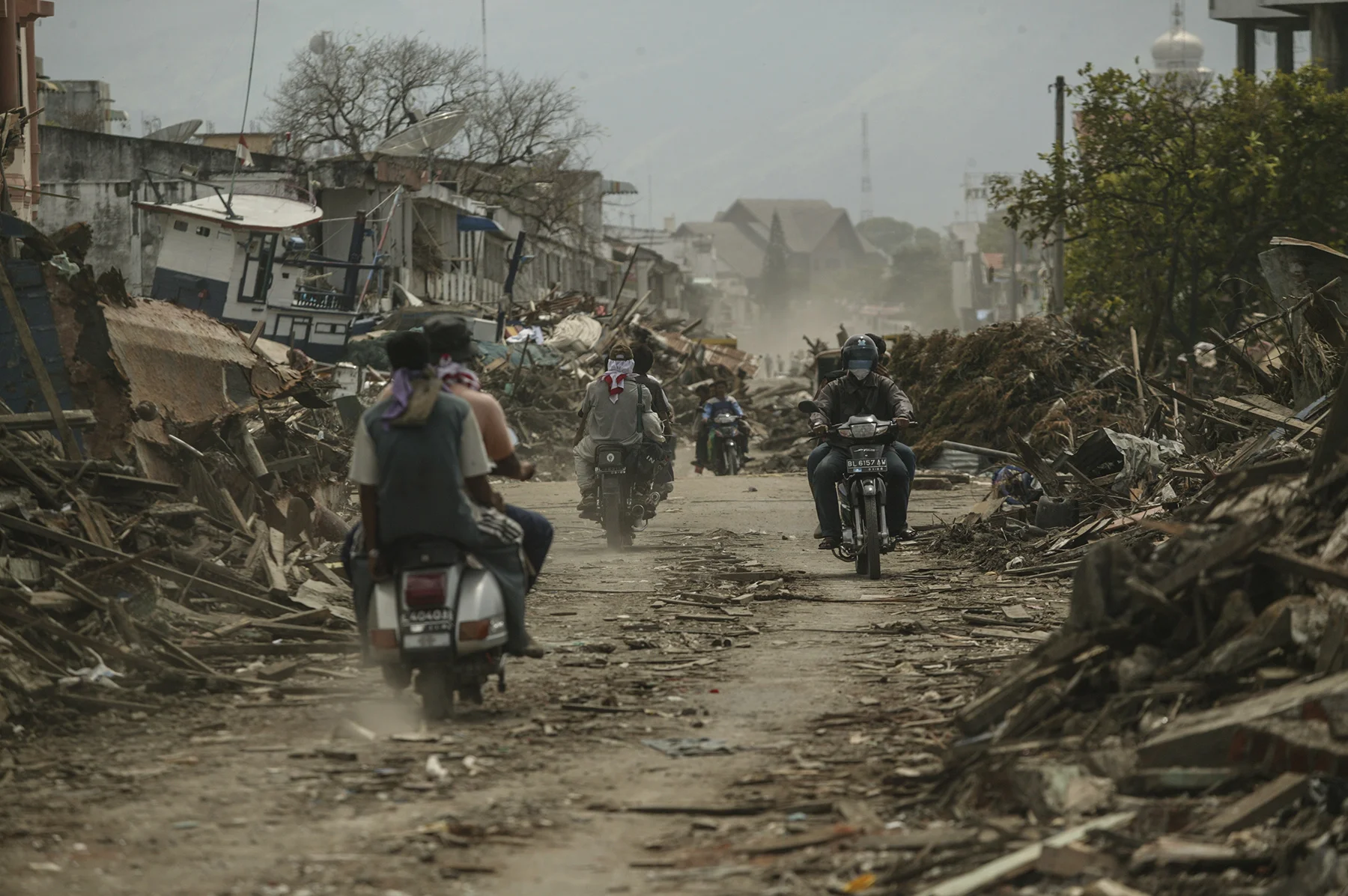 Residents of Banda Aceh ride through their town.