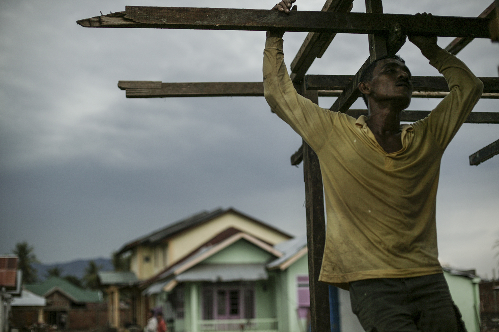  Exhausted, a man takes a moment of rest&nbsp;as he rebuilds his home.&nbsp; 