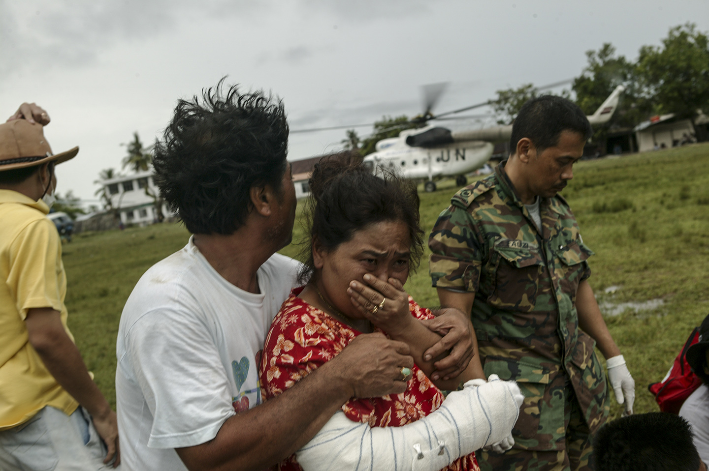 Injured survivors wait for helicopter transportation.