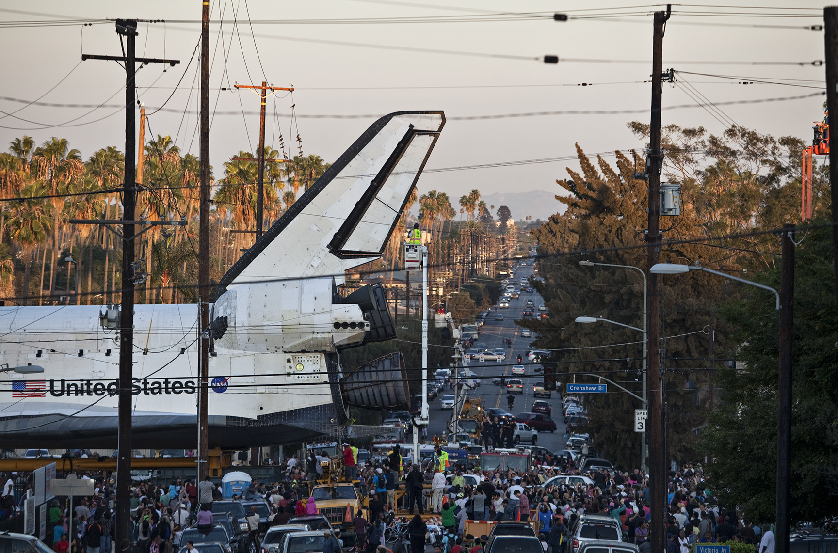 Space shuttle Endeavour makes its way through a Los Angeles neighborhood during a 12-mile land journey from the Los Angeles International Airport to the California Science Center, which is now its home. 