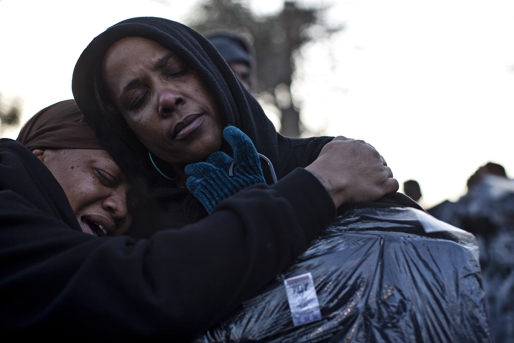  Fans of Whiney Houston&nbsp;embrace at a vigil held for the late singer. 