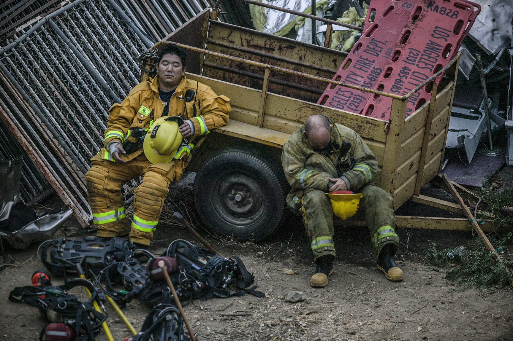  Exhausted firefighters find a moment of rest at the scene of a deadly train crash where 25 people lost their lives.&nbsp; 