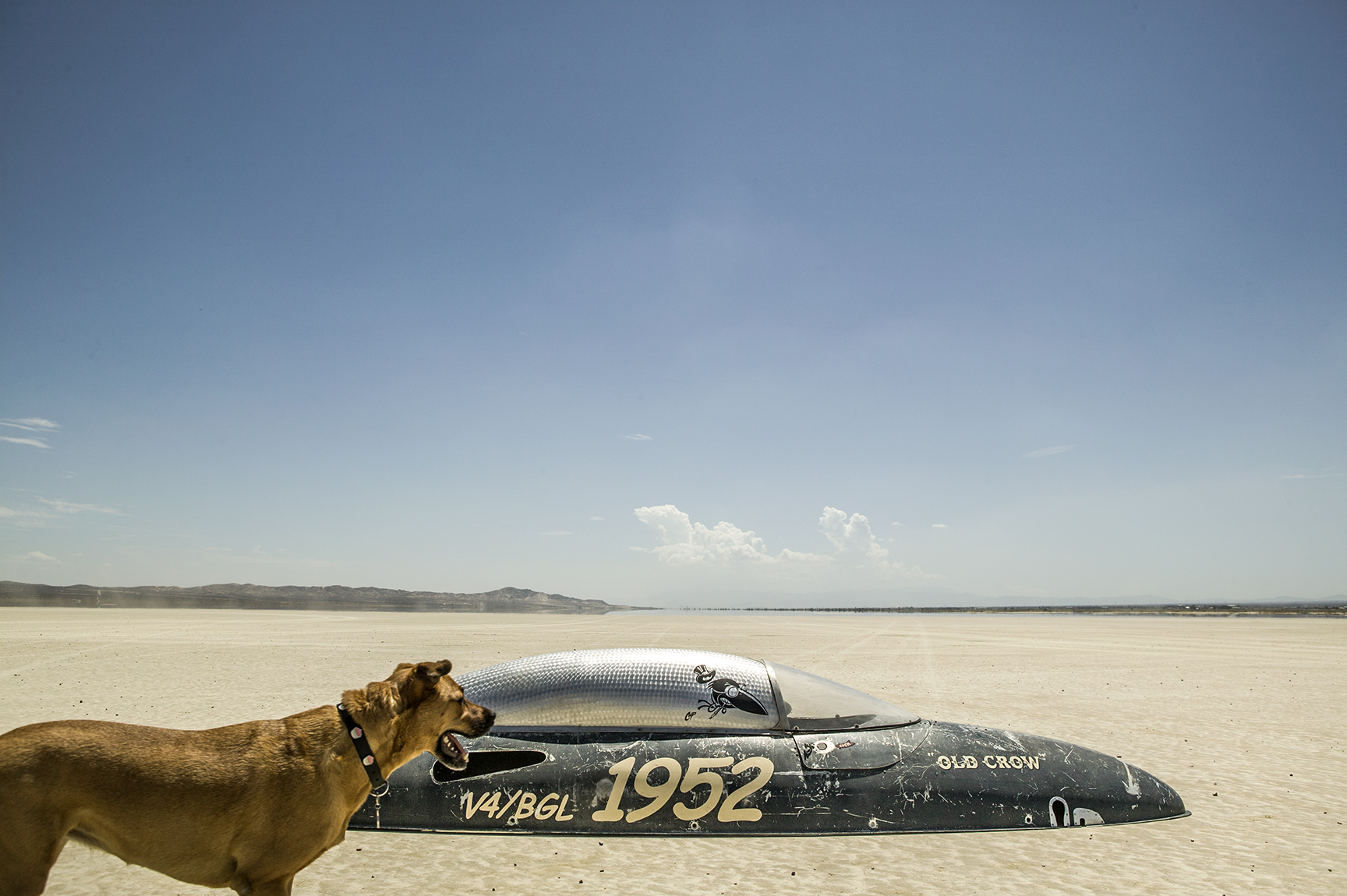 The canopy of a belly tank race car out in the Mojave desert. 