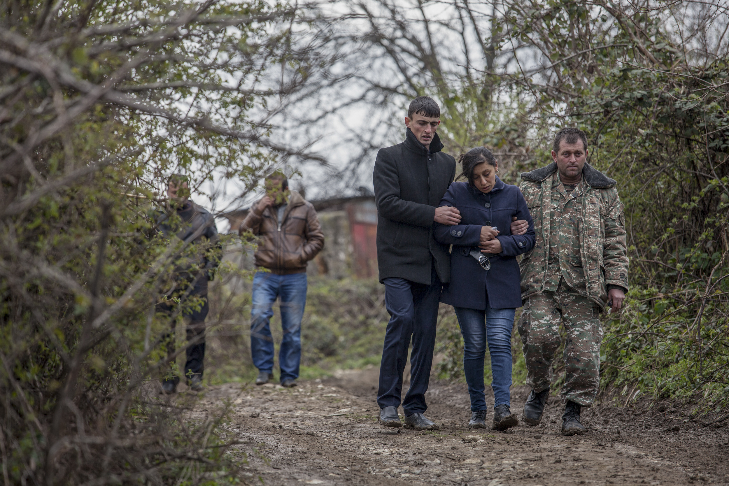The mother of 12-year-old Vagharshak Grigoryan is escorted by her husband, right, after the boys funeral. The boy was killed when Azeri Grad rockets hit their village during the first day of fighting on April 2.