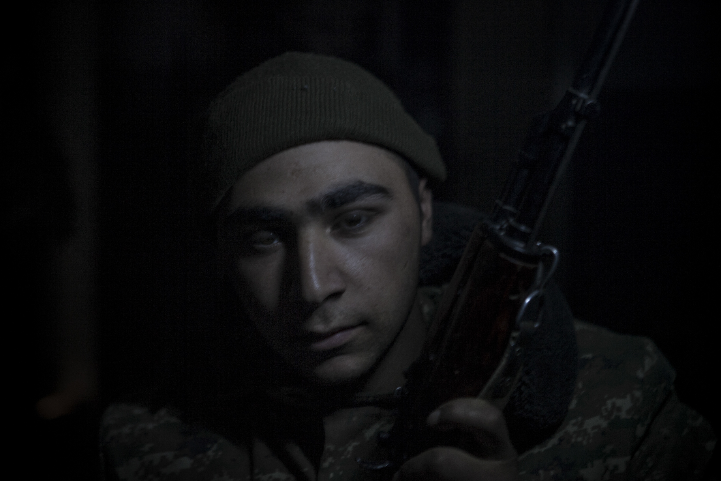  Soldiers awaiting orders in darkness, lit only by kerosene lanterns, at a military base in Mataghis, Karabakh on April 5. 