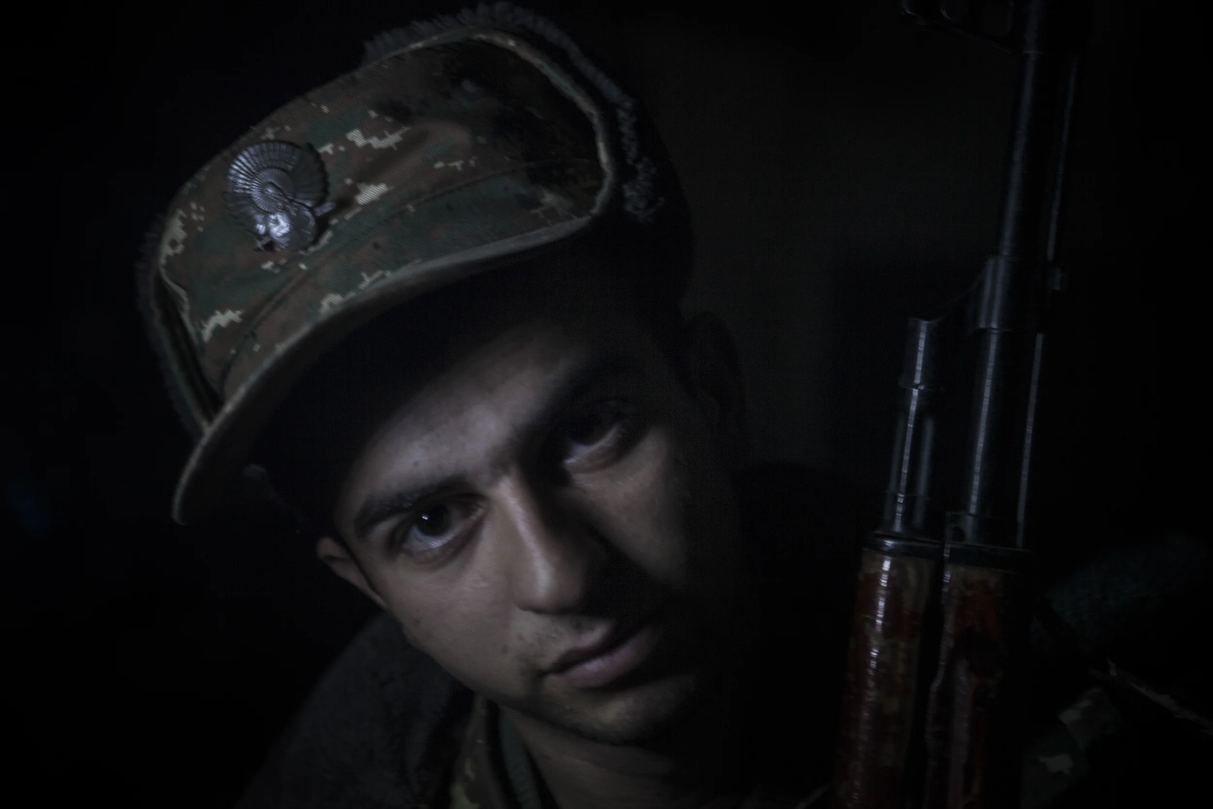 Soldiers awaiting orders in darkness, lit only by kerosene lanterns, at a military base in Mataghis, Karabakh on April 5.