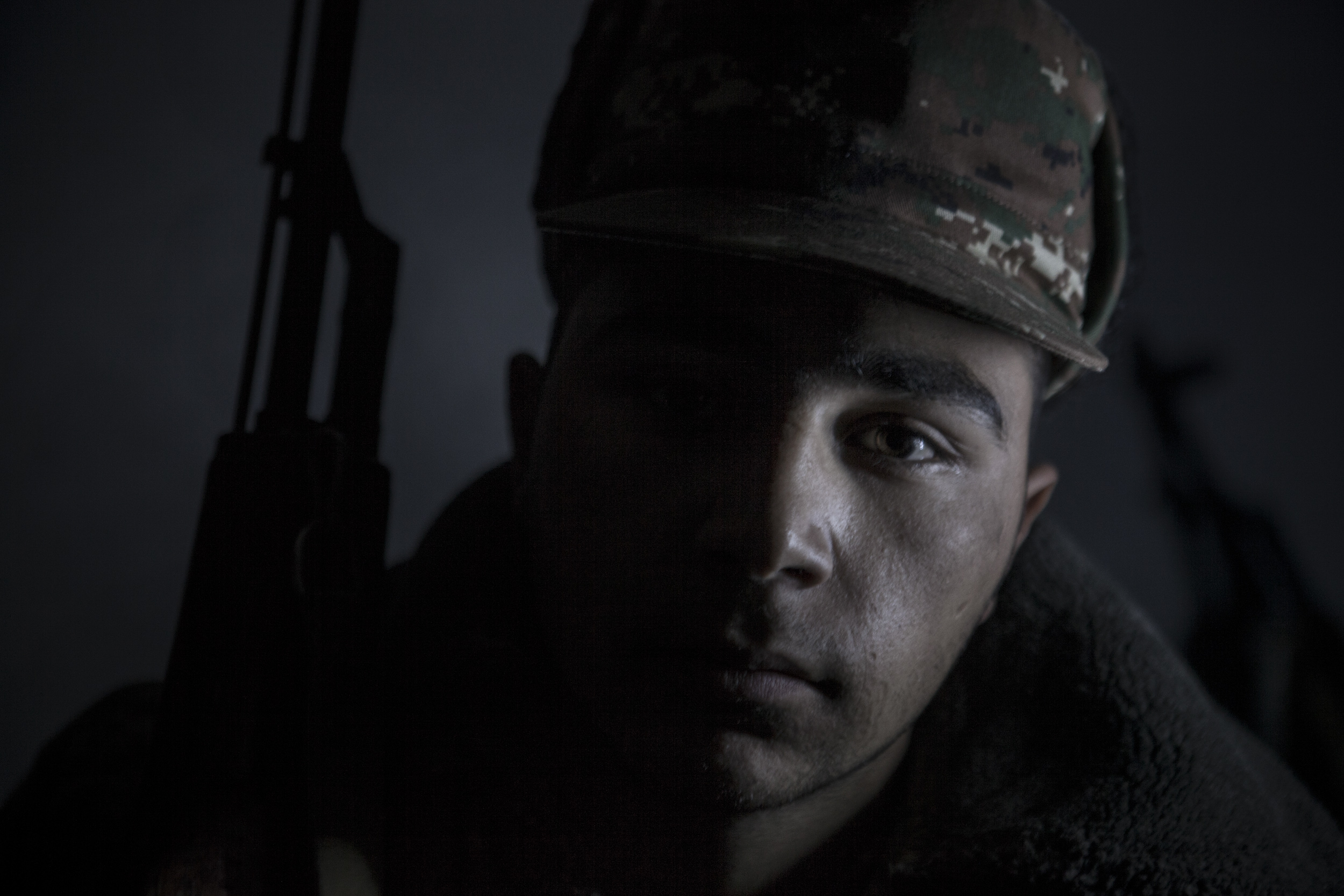 Soldiers awaiting orders in darkness, lit only by kerosene lanterns, at a military base in Mataghis, Karabakh on April 5.