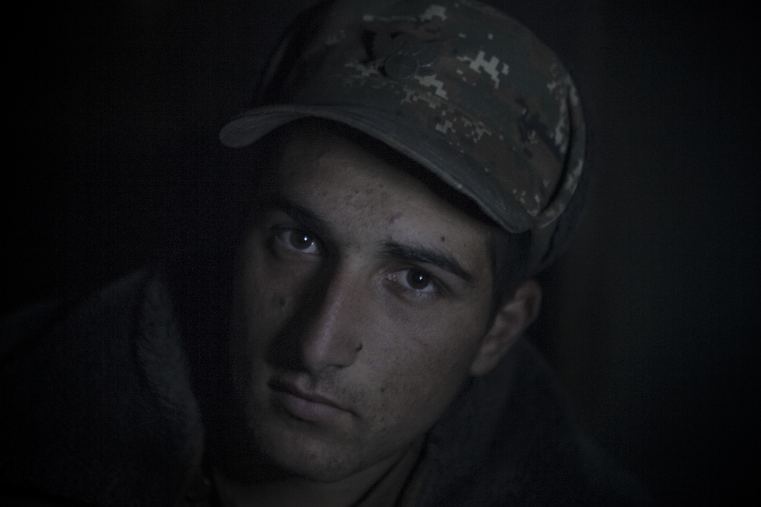 Soldiers awaiting orders in darkness, lit only by kerosene lanterns, at a military base in Mataghis, Karabakh on April 5.