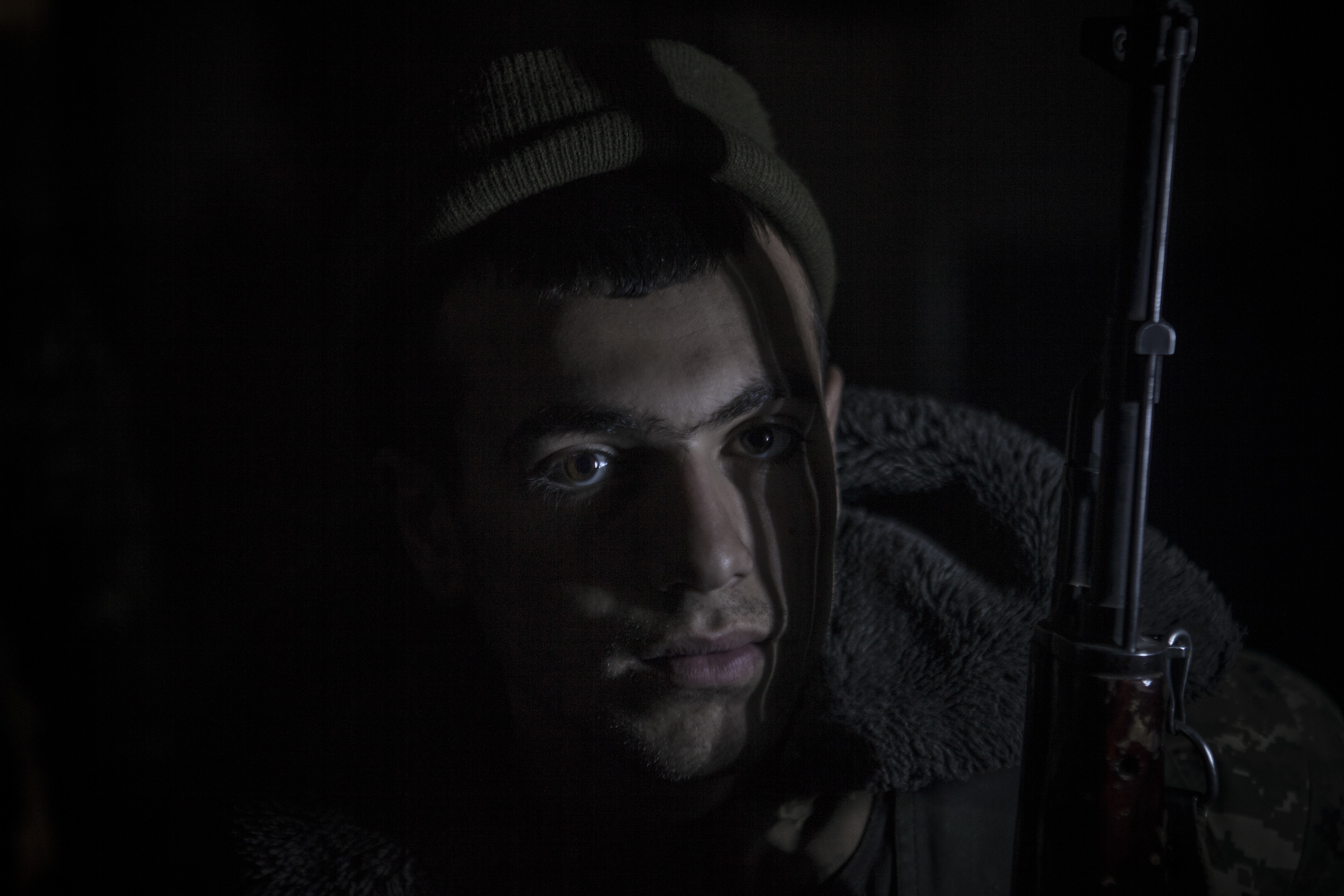 Soldiers awaiting orders in darkness, lit only by kerosene lanterns, at a military base in Mataghis, Karabakh on April 5.