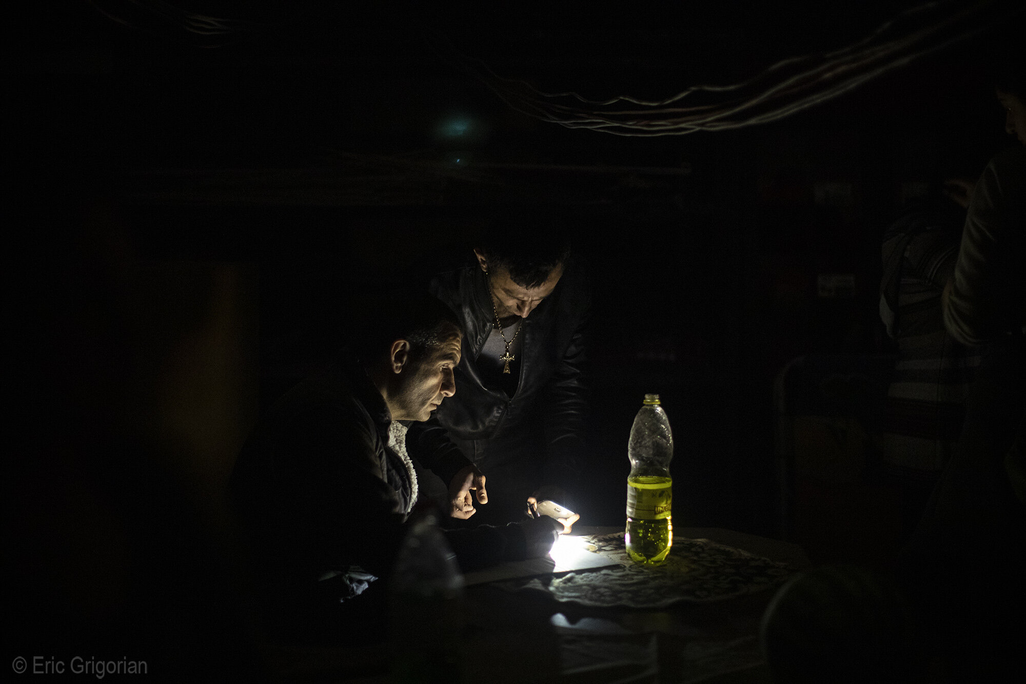  After a night time bomb strike on a residential neighborhood of Stepanakert officials in a makeshift bunker of one of the hit buildings gather names of residents wanting to be evacuated from the city. 