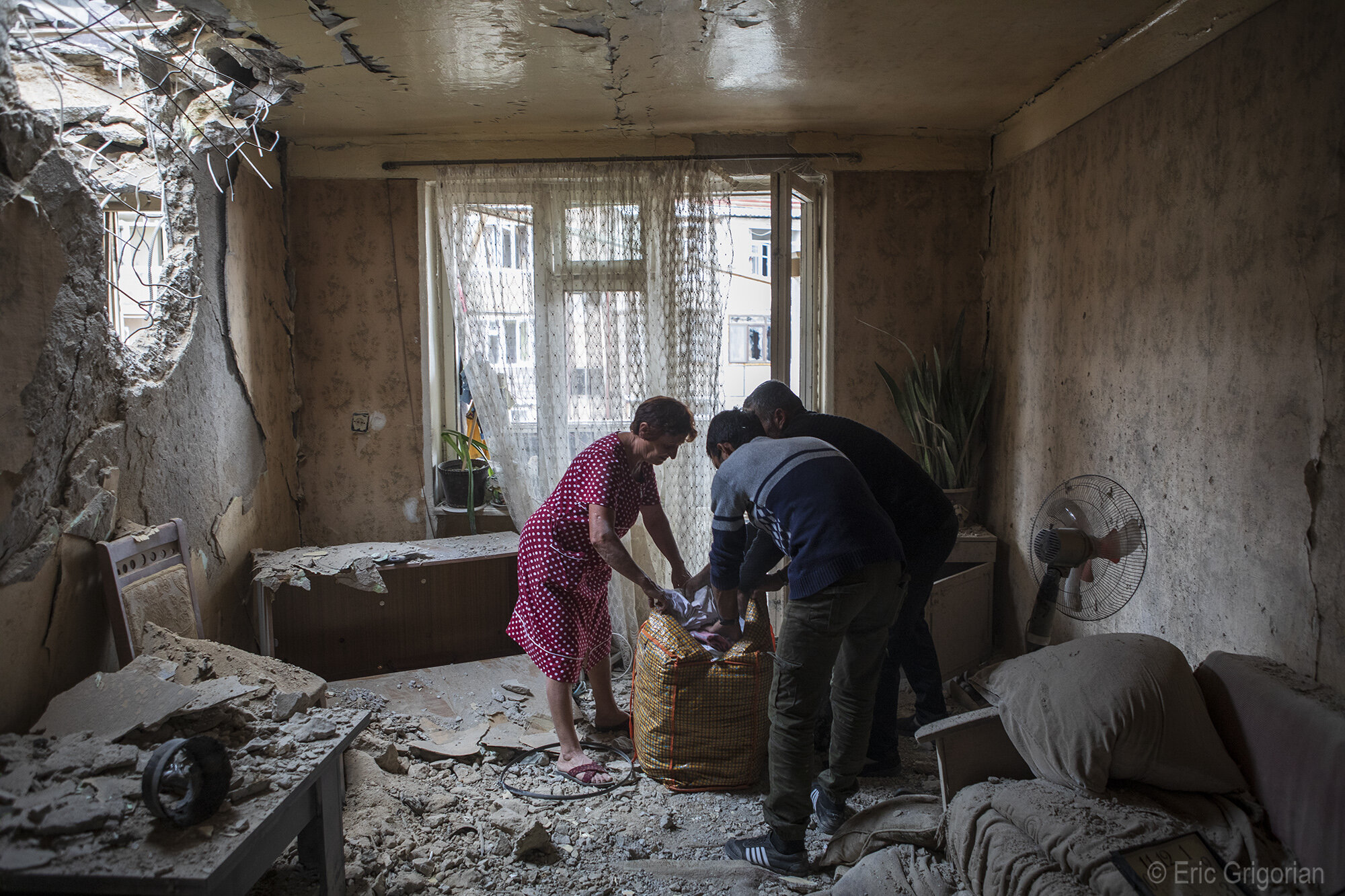  The morning after shelling in Stepanakert, residents of the buildings that were severely damaged return home to salvage whatever is left of their belongings. 