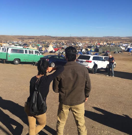 Chelsey & Thosh overlooking Oceti Sakowin camp. Photo by Bobby Wilson. (We swear it was actually candid!) 