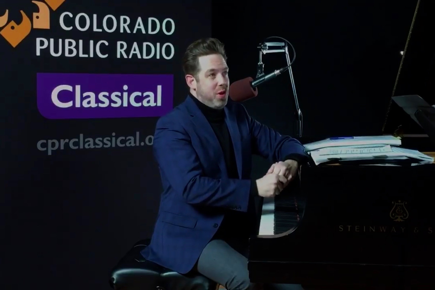 Brett Mitchell at the piano in the Colorado Public Radio studios. (Photo by Hart Van Denburg/CPR)