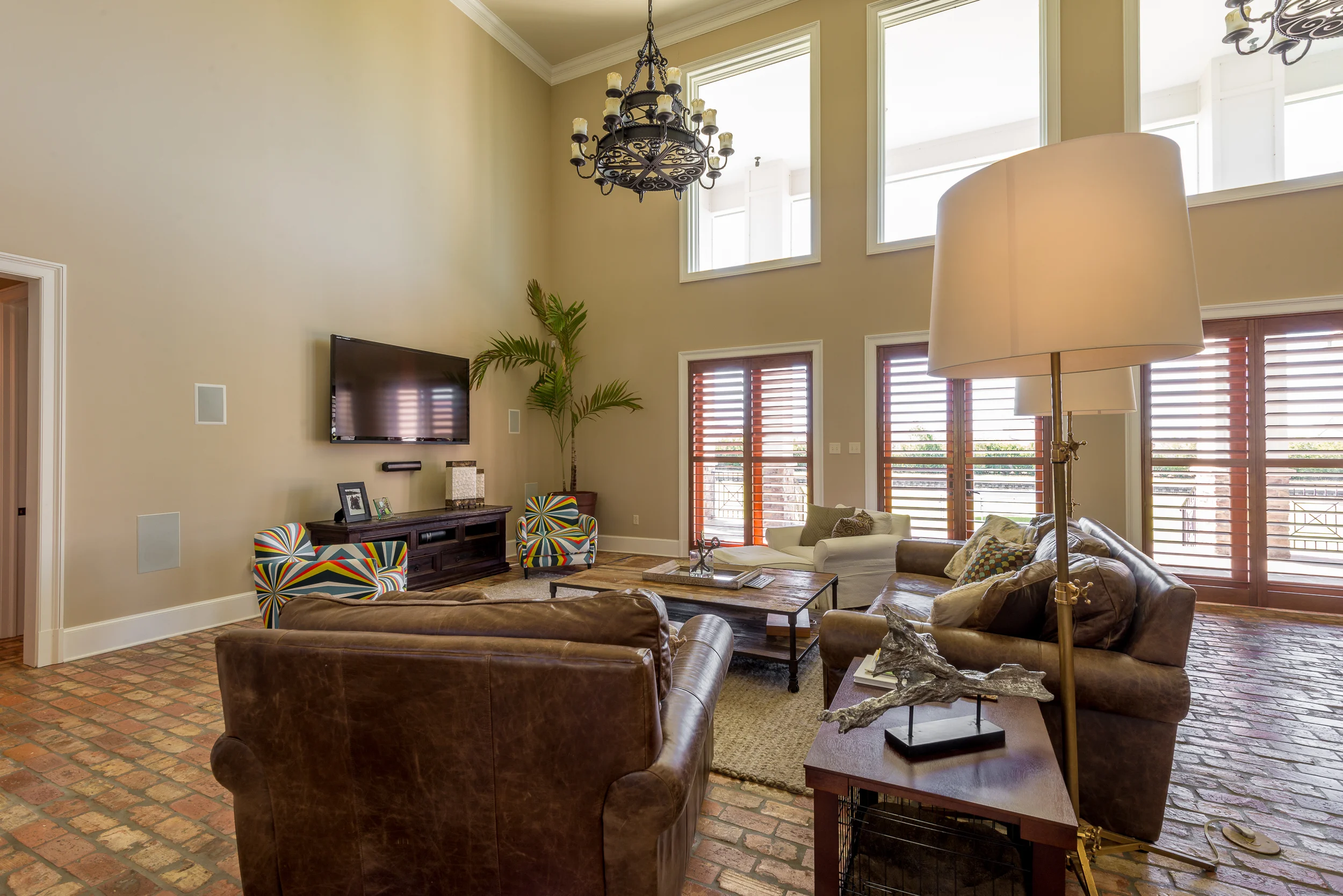 Keeping things at eye and ear level was the goal in this gorgeous and massive living room.  A hidden closet full of electronics and an RF remote keeps the whole-house system under control.