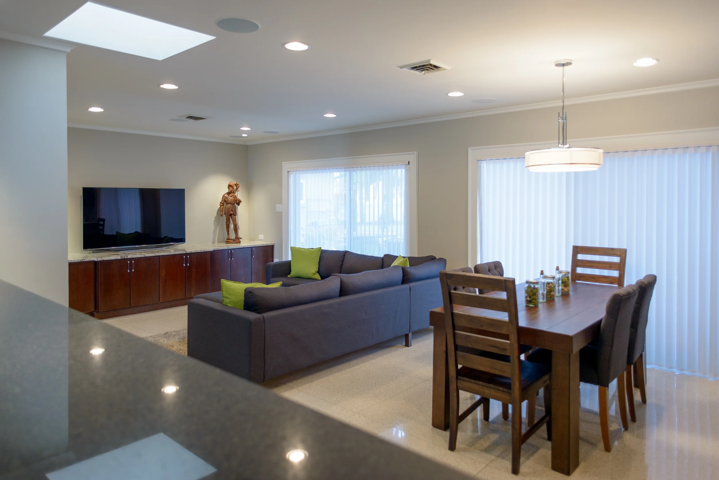 Sonance recessed speakers and subwoofers, along with hidden electronics powered by Denon don't intrude on the simplicity of this beautifully understated living area.