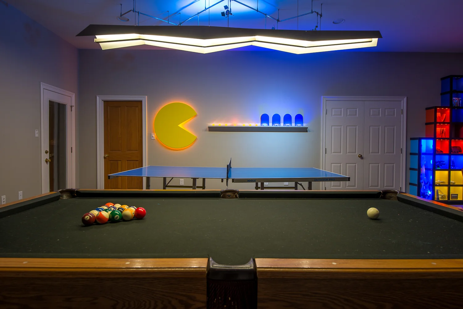 The "Pac-Man Wall" was designed to house all of the ping-pong balls and paddles.