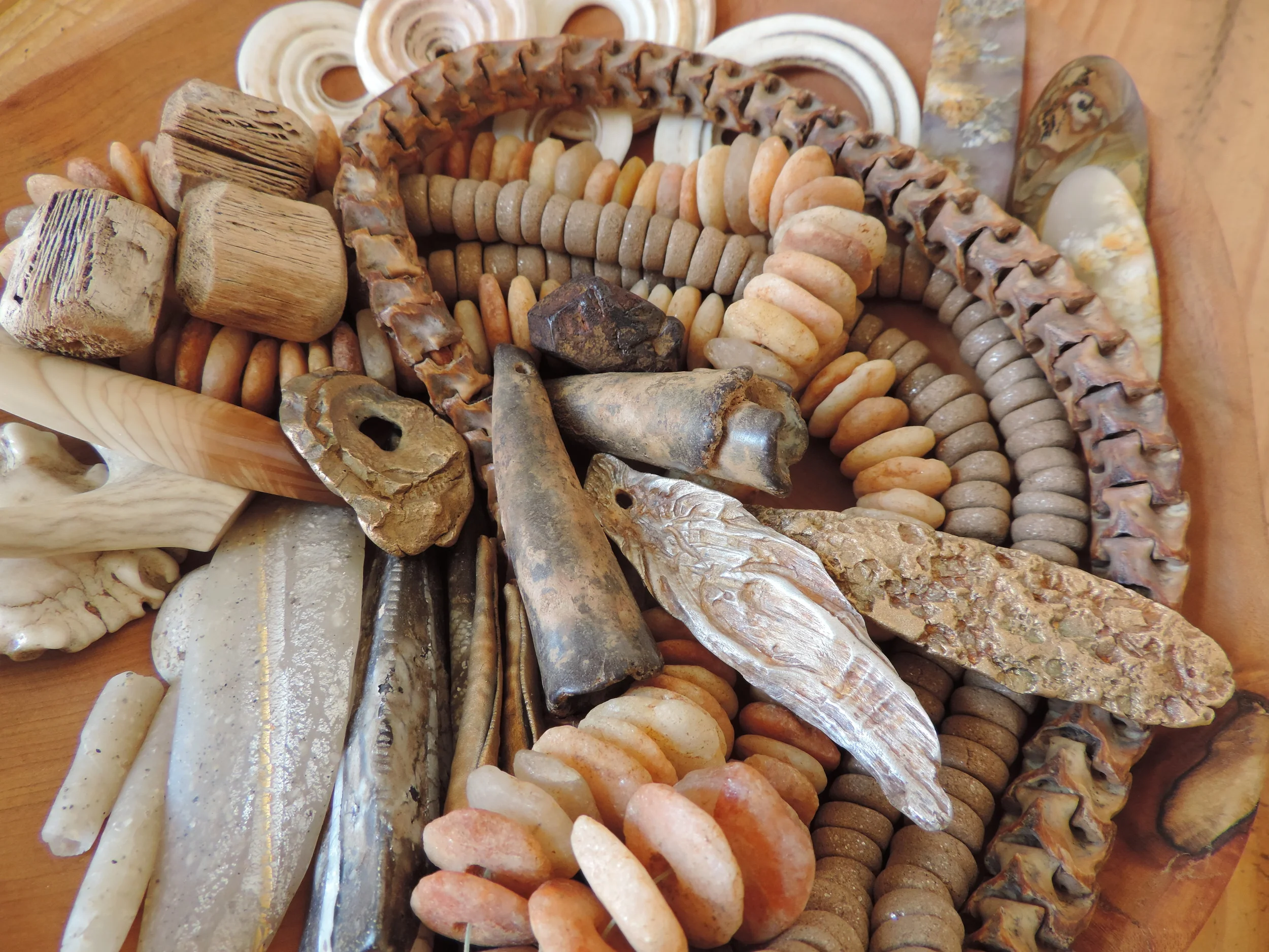 Favorite components of silver and bronze metal clay, polymer artifacts, ancient stone, snakebones, Taos clay, saguaro rib beads, and more.