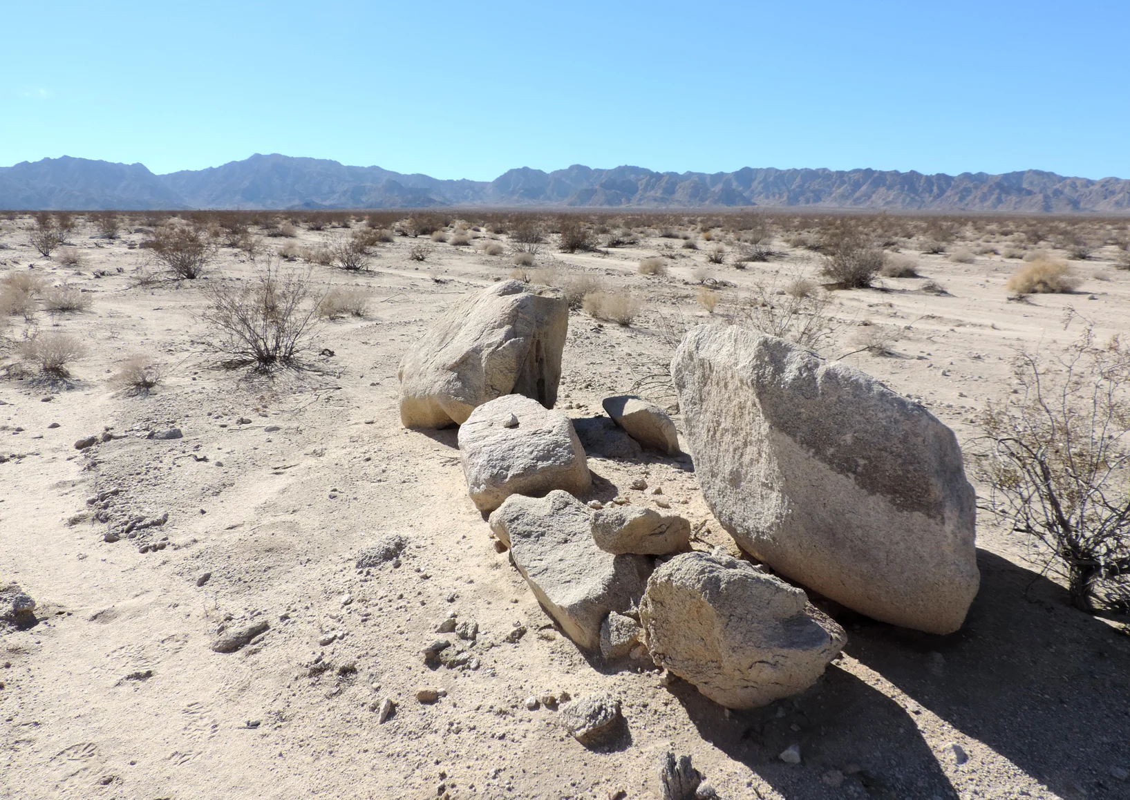 The white granitic bajada of the Cadiz Valley, with Calumet and Sheephole Mountains in the distance. Mojave Desert, California.