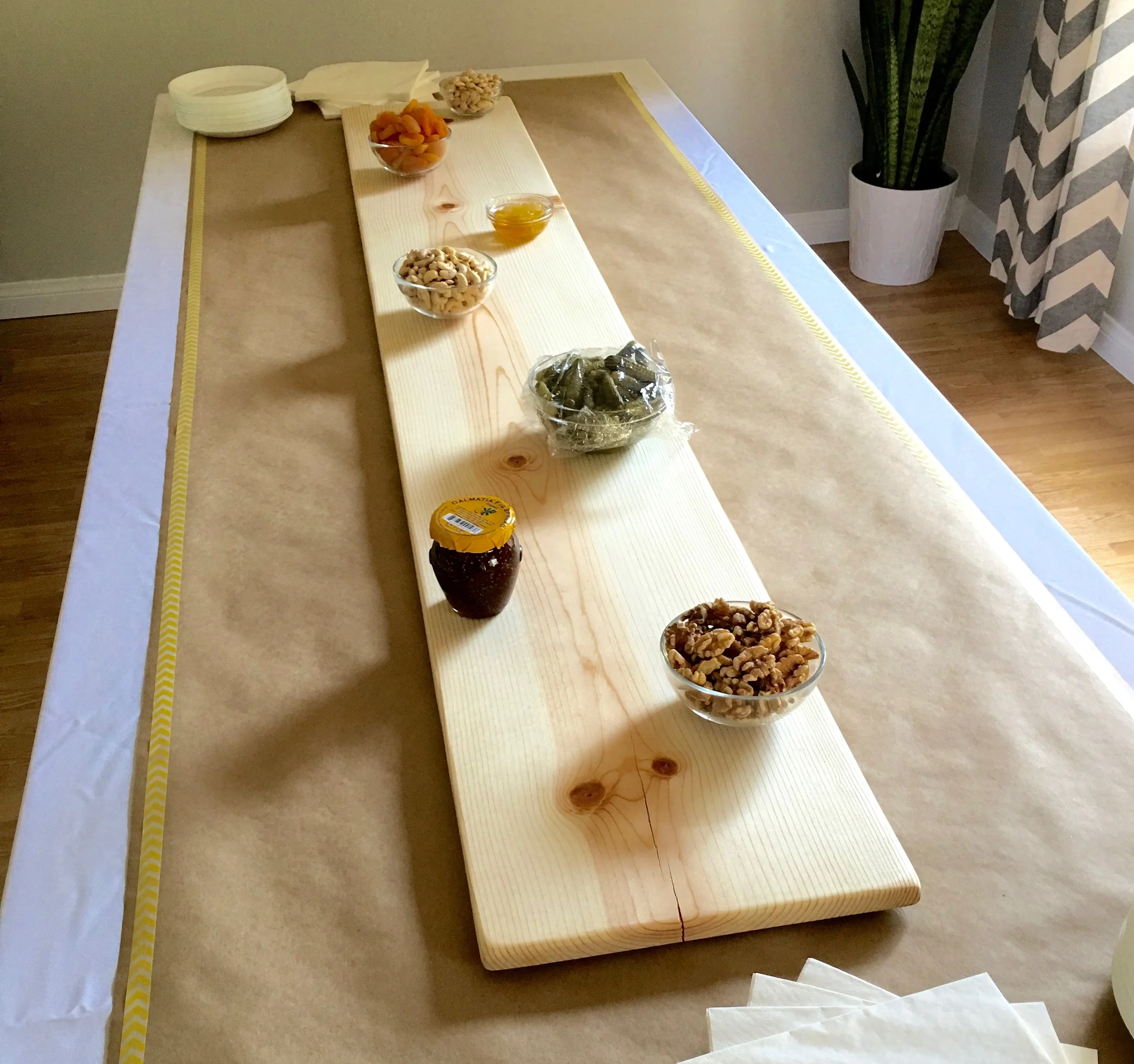 Next, I collected all of the small glass bowls I had and filled them with anything that would get wet or messy. A lot of people choose to put everything directly on the wood board, But since this was an exceptionally large board serving a lot of people, I wanted to make sure it stayed presentable throughout the evening and I feel the bowls helped with that. 