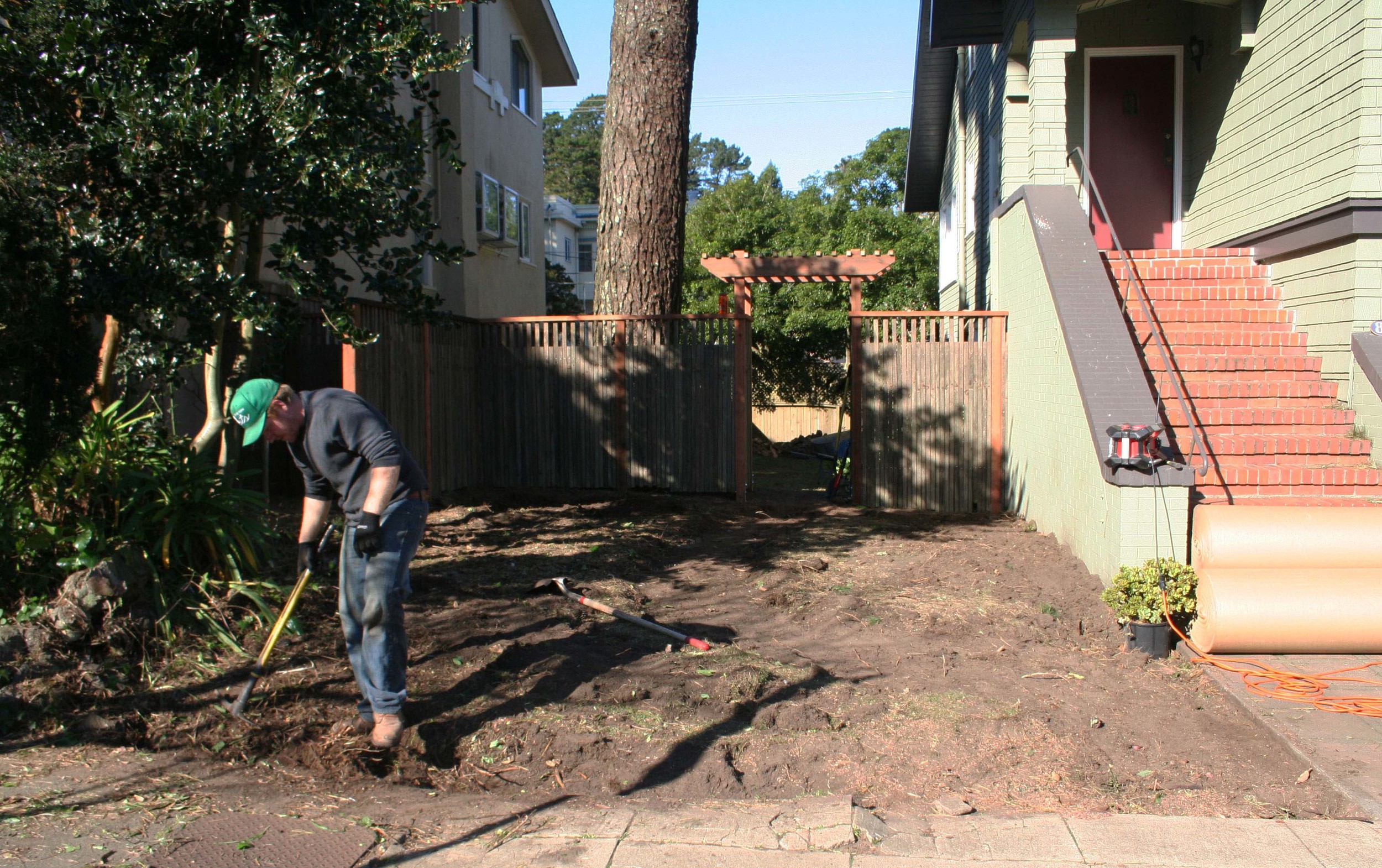The first step is to grade the site, laying out and excavating for a path, and making sure to provide enough space around the edges for the additional compost and mulch.