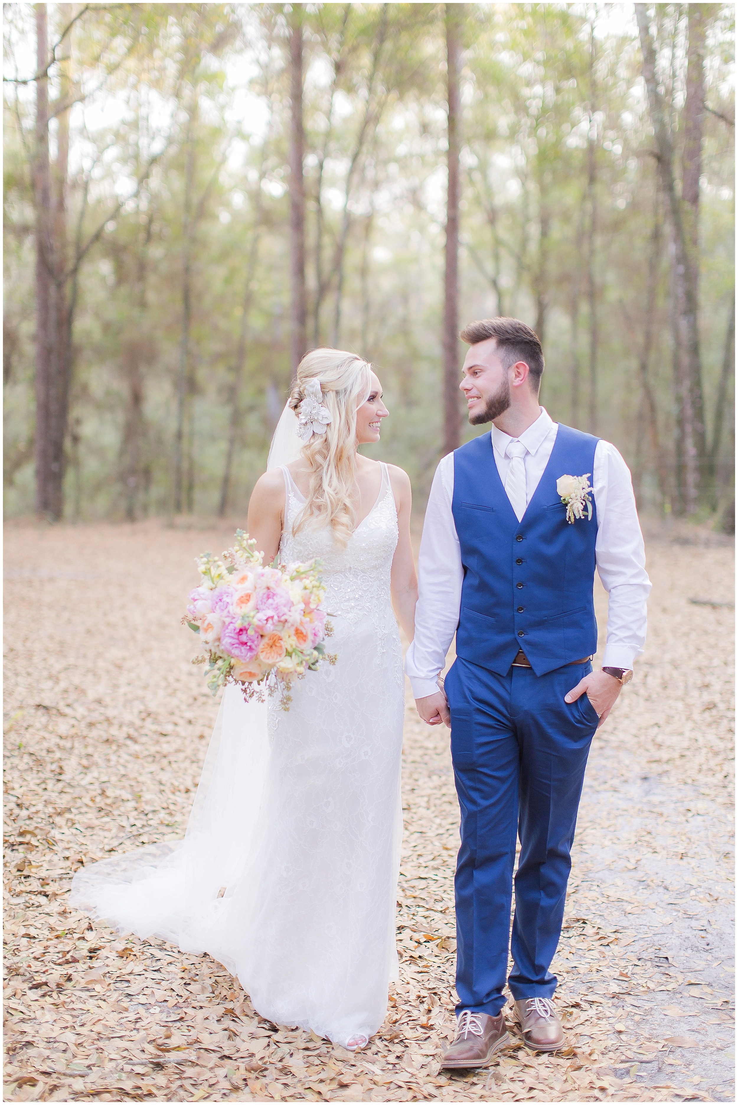Bride and Groom Walking in the Woods After Rustic Wedding 
