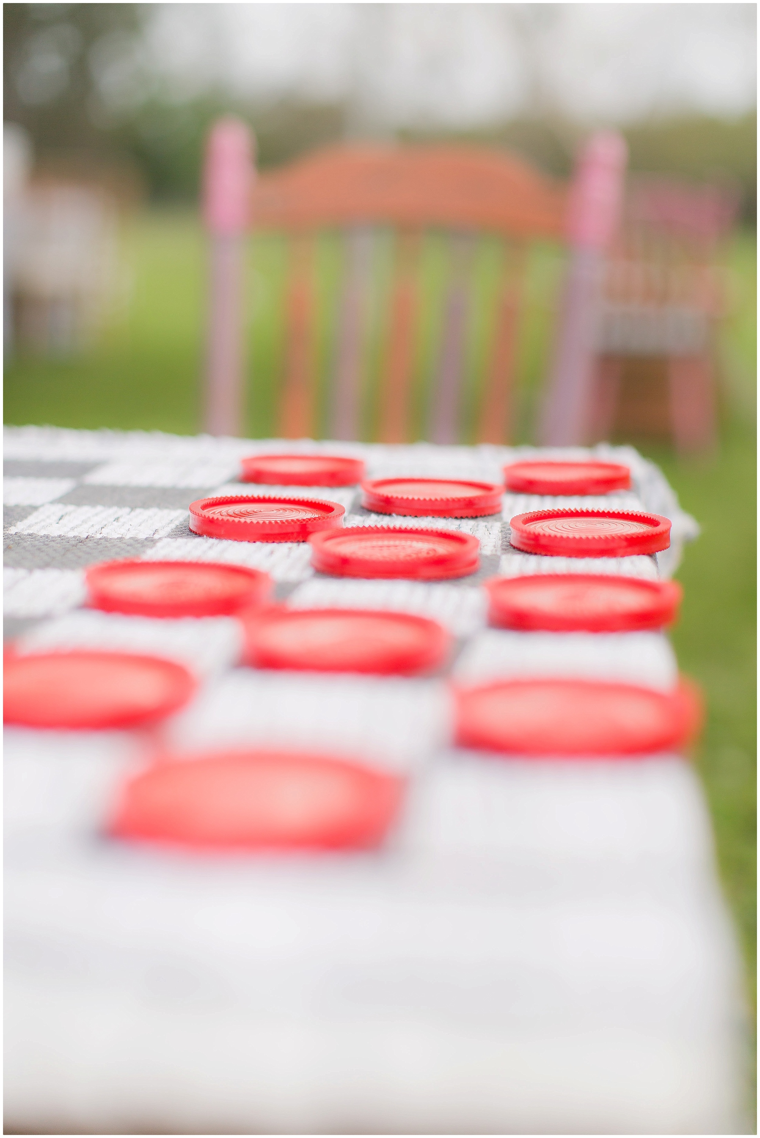 Checker Board Game At Outdoor Reception. 