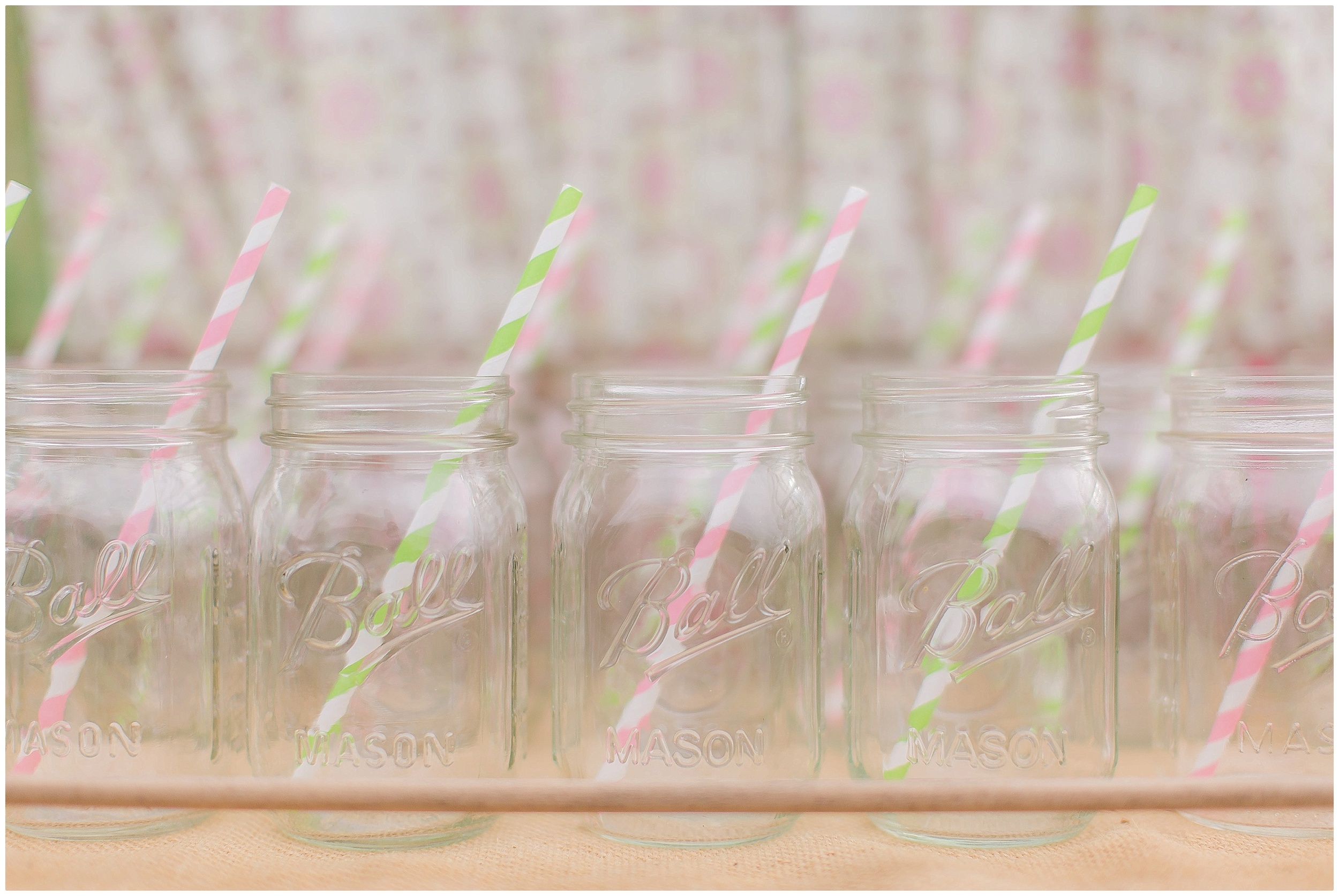 Mason Jar Glasses with Pink and Green Straws to make their Vintage decor. 