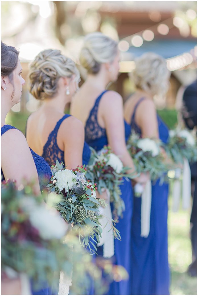 Navy Bridesmaids Dresses and white bouquets with berries 