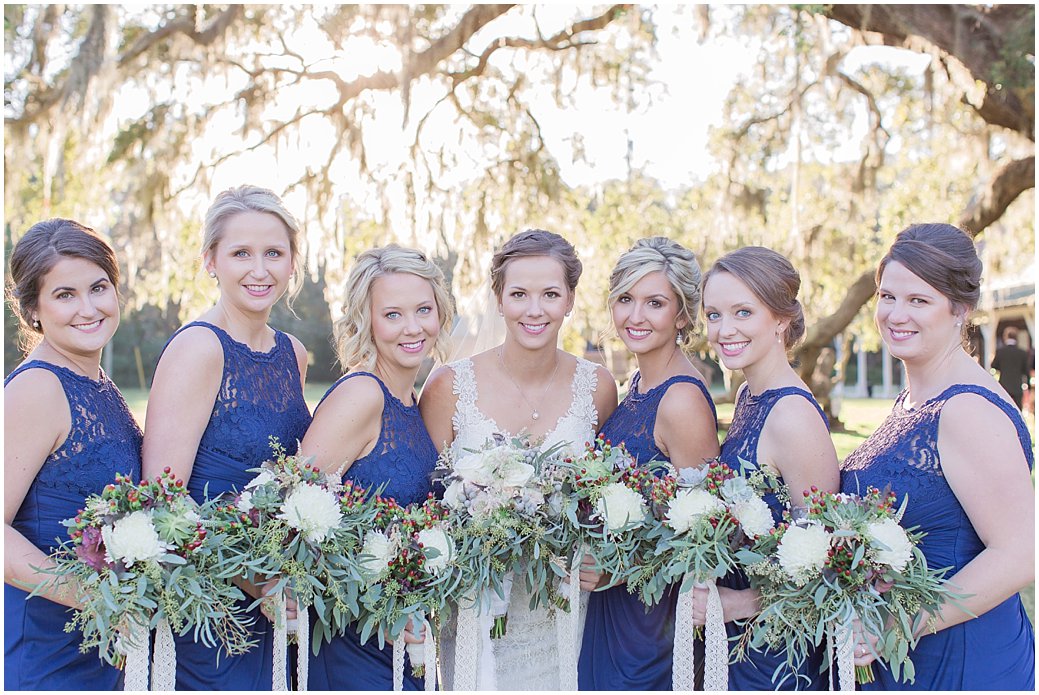 Bridesmaids in Navy with White Bouquets with berries and lace ribbon 