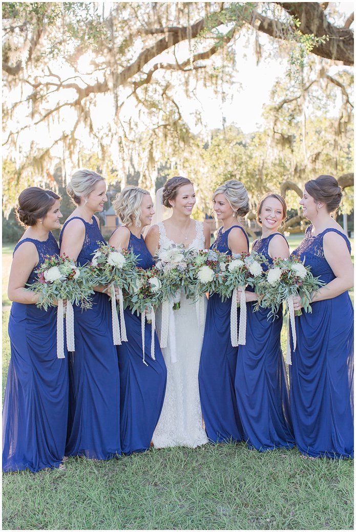 Bridesmaids in Navy with White Bouquets with berries and lace ribbon 