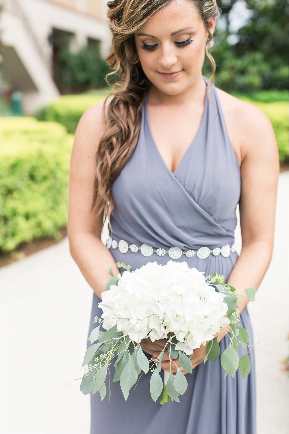 Grey bridesmaid gown and white bouquet at Wyndham Grand Resort at Bonnet Creek wedding by PSJ Photography 