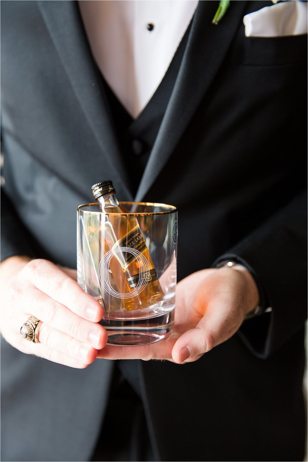 Groom gifts to guys of whiskey glasses and nips in classic tux with white vest and bowtie getting ready moments at Bonnet Creek Wedding by PSJ Photography