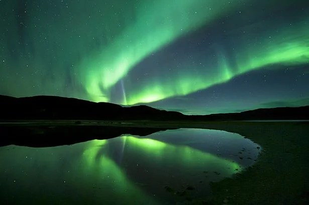 Aurora borealis, the spectacular Northern Lights turn the sky green at Ifjord in Finnmark, Norway.jpeg