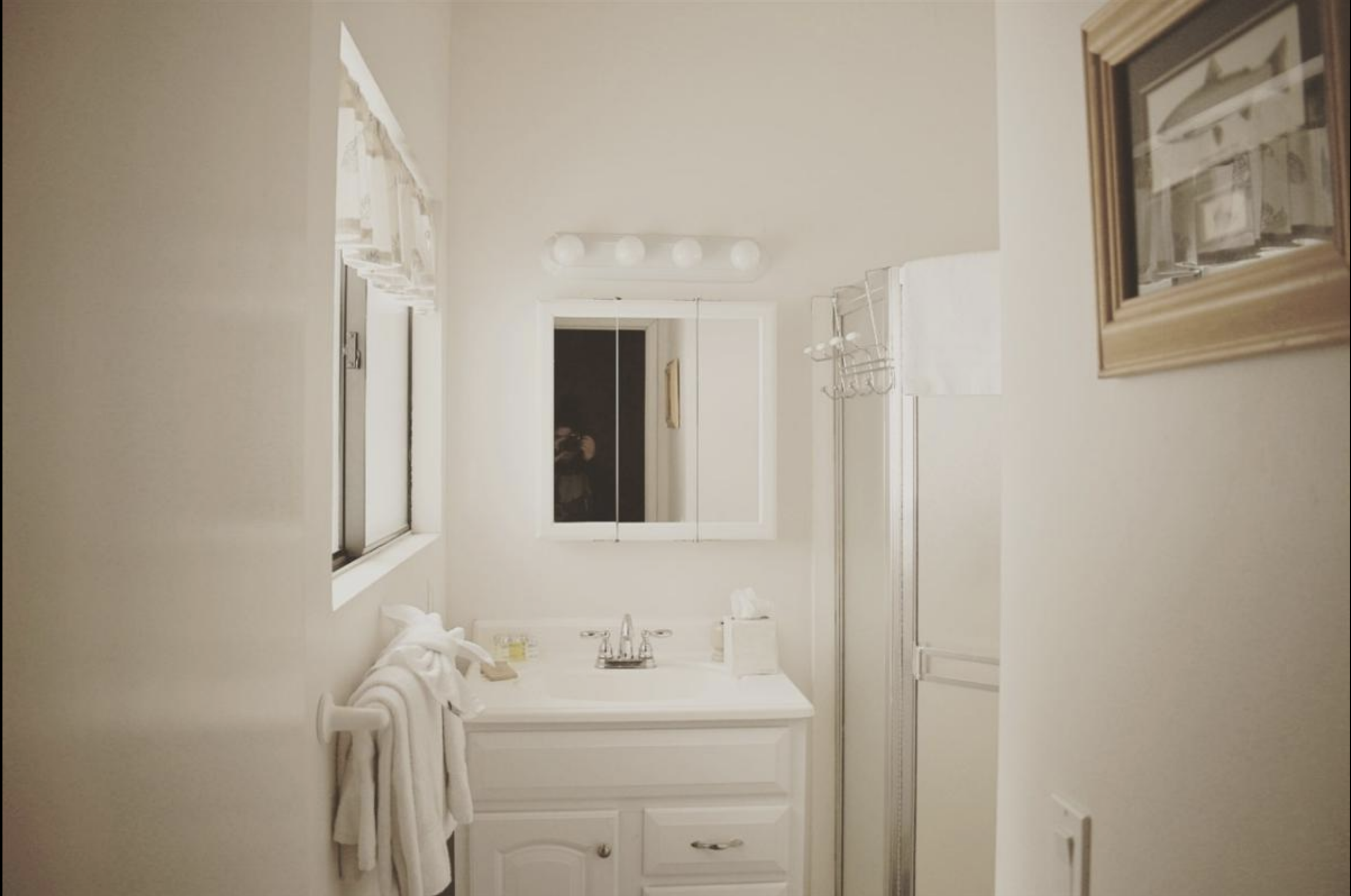 Bathroom 1 of 2. Nothing, not even that lace valance, makes me more angry than the uncentered medicine cabinet and light fixture. It all must go. 