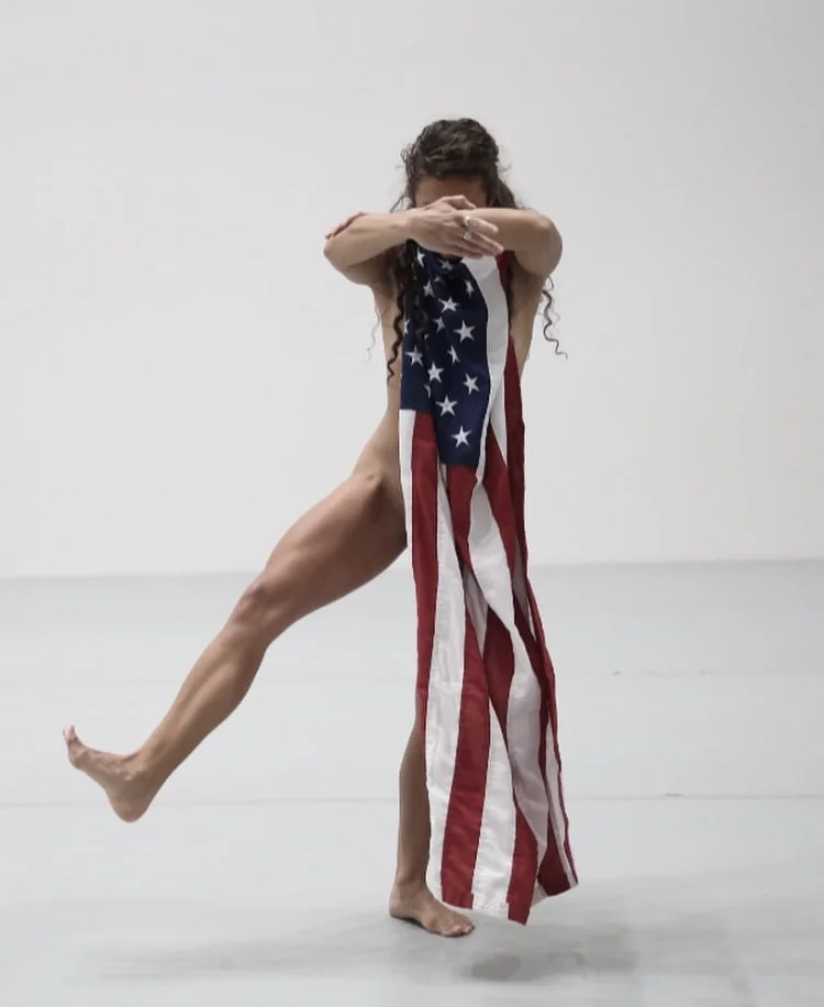 Mary Kate in Yvonne Rainer’s Trio A with Flags performed at New York’s Museum of Modern Art Photo by Paula Court, Museum of Modern Art