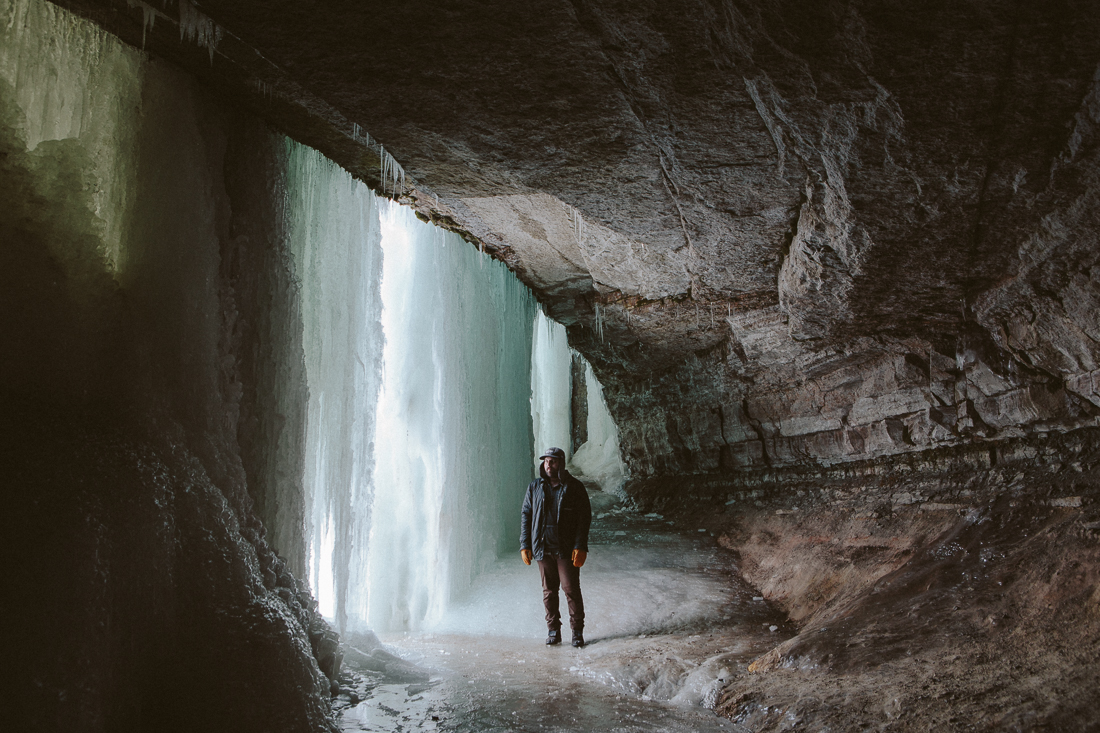He took me to a waterfall off the Mississippi River that was completely frozen. We trespassed and hiked behind it, so I could make this rad photo of him. 