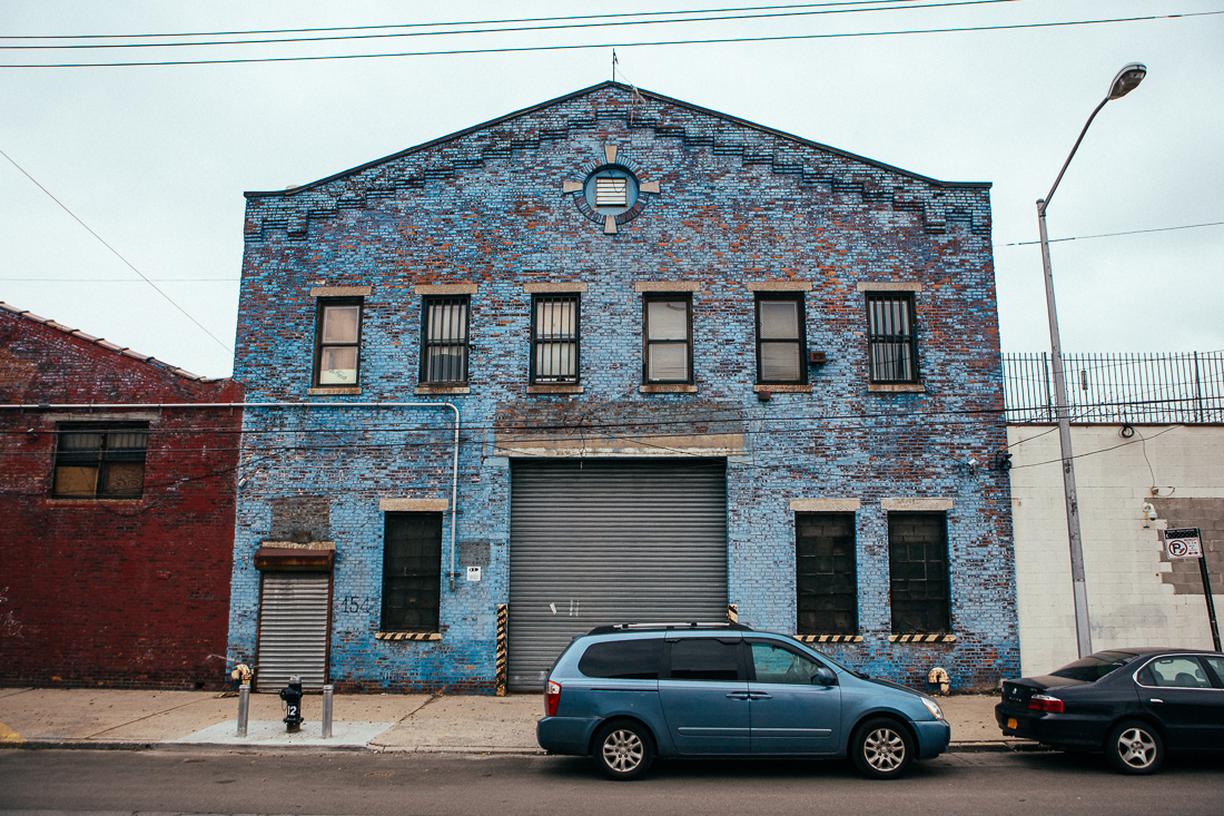 The weathered painted brick on this building is something you can't recreate without time. The blue vehicle really made this picture come together.