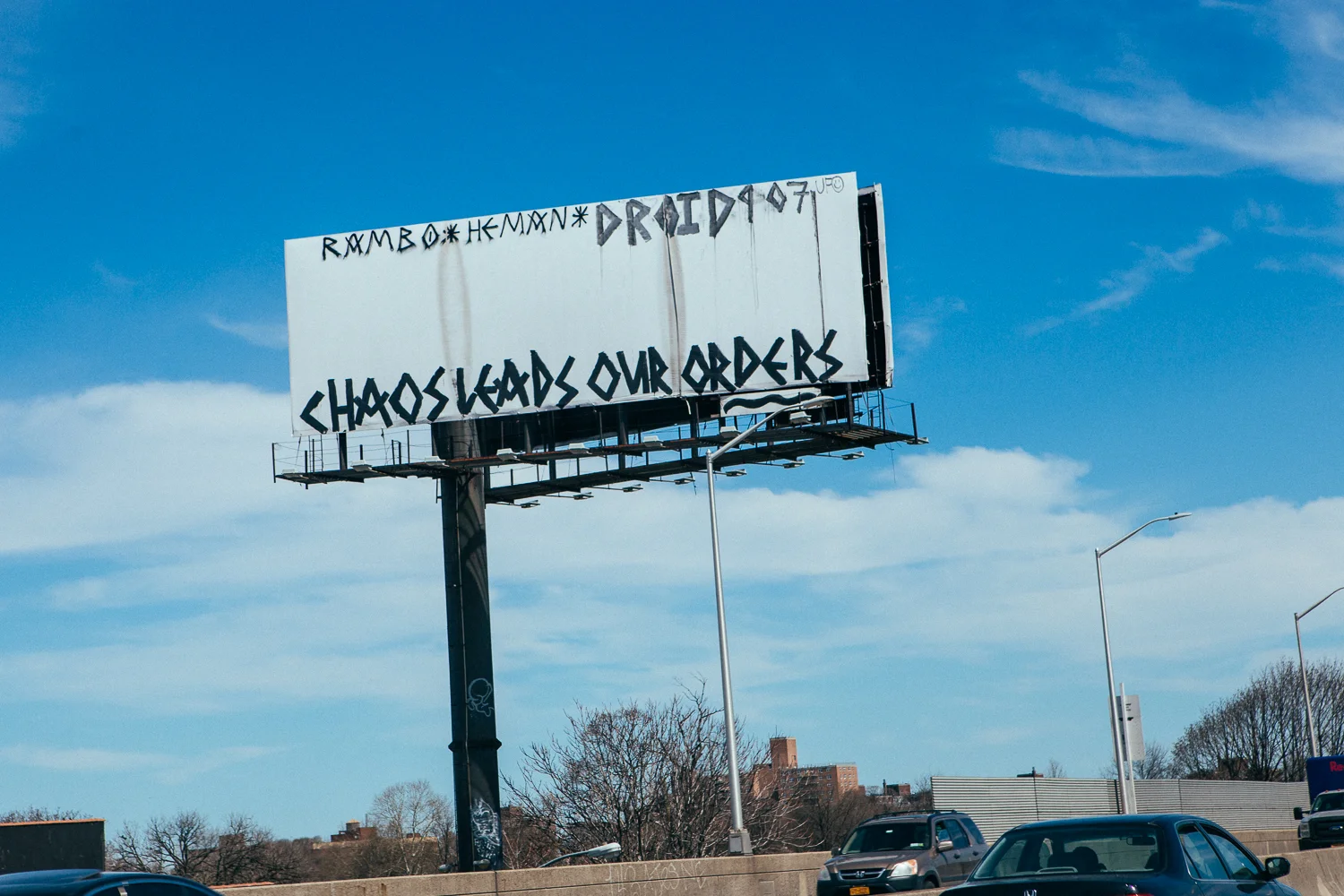 An empty billboard is a NY street artist's canvas for a political statement. 