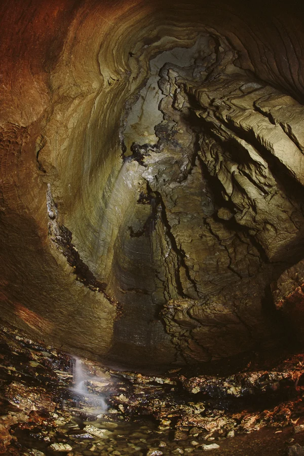 At the end of the cave is this insane&nbsp;35' tall waterfall!&nbsp;To be able to make this pic, I opened the shutter for 10 seconds and had to wave&nbsp;my headlamp around&nbsp;to expose the full&nbsp;photo. I couldn't light the actual water fallin…
