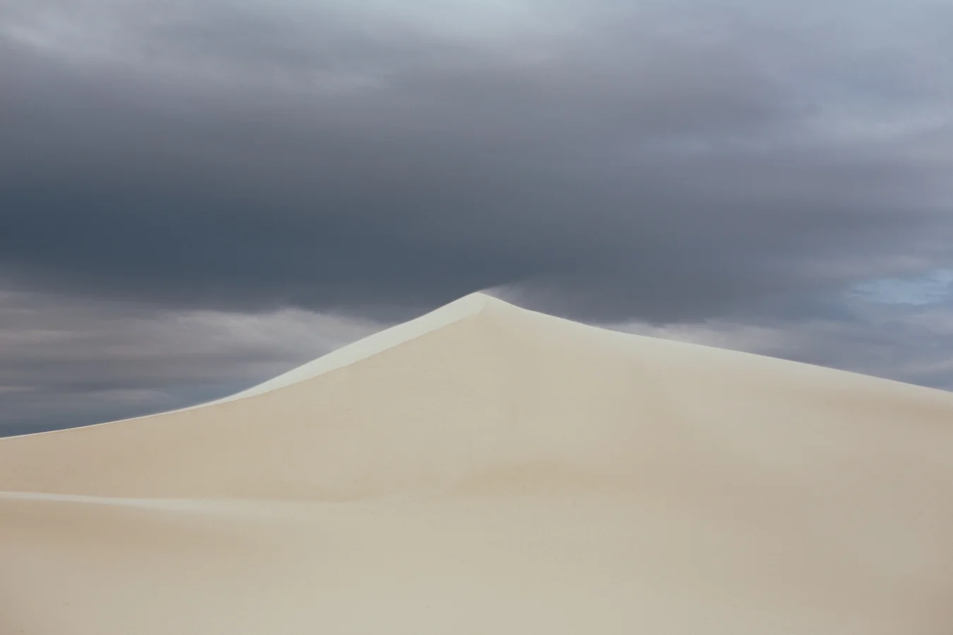 The winds pick up near sunset, launching the sands off the peak for dramatic scenes like this.