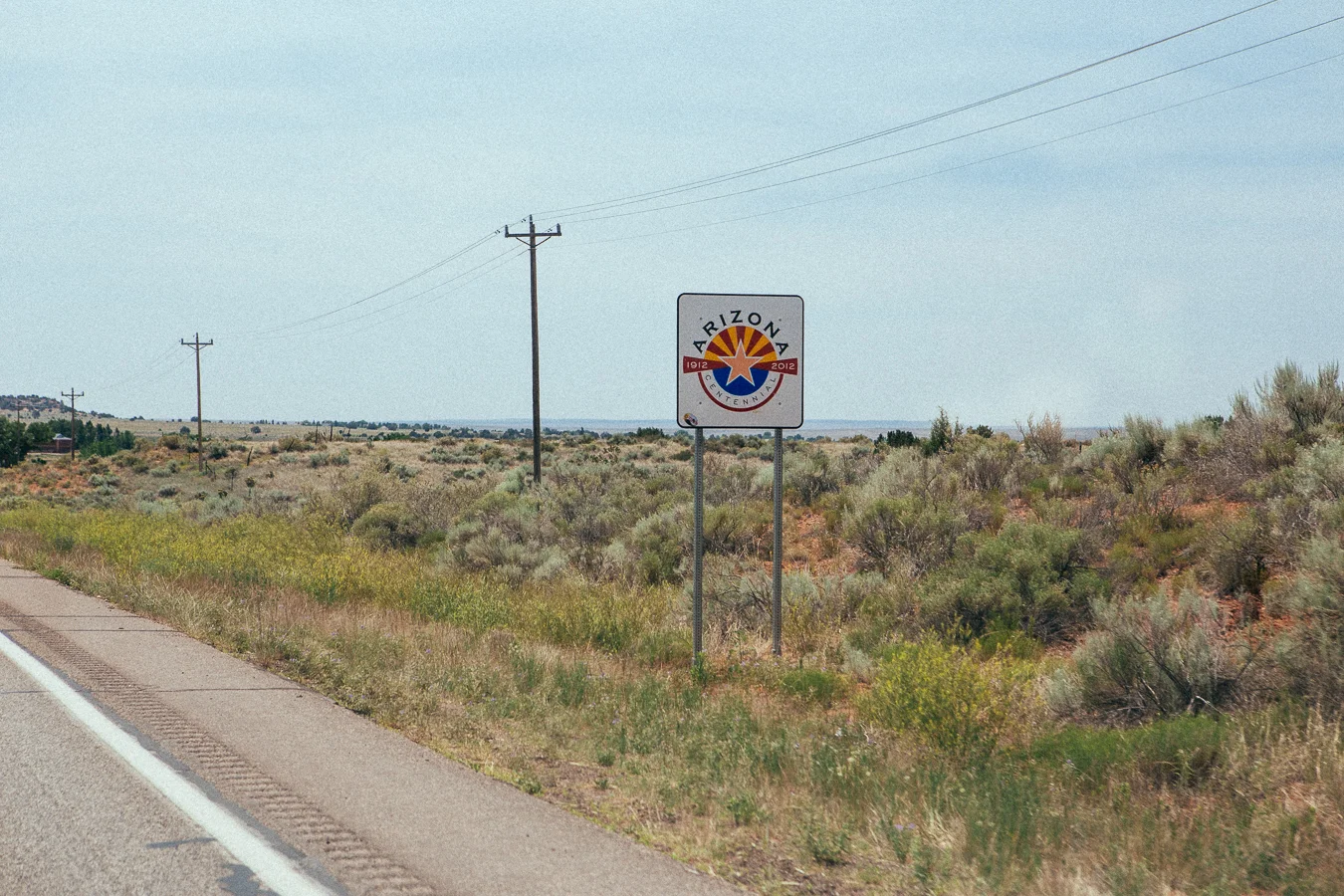 On this smaller and less-trafficed highway the state sign was boring with it's lack of welcome. Nice design though.