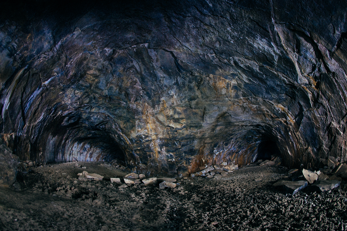 It's pitch black in here. (30 second exposure lit by running around with a headlamp shined all over the walls) This section the lava carved 2 tunnels; go left or you have to crawl on your elbows to reconnect to the main cave. The ground is sharp rough lava that cooled in place, so take my advice and GO LEFT.