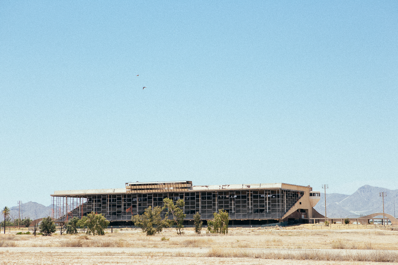 After driving hours through the 115º+ heat, I found the abandoned Phoenix Trotting Park horse racetrack. Unfortunately, about a year ago security measures were beefed up to stop Urban Explorers like myself from access. It was so hot that I wasn't really down for the mission that was needed to make this one happen. This shot was from an illegal point, so it was still exciting.