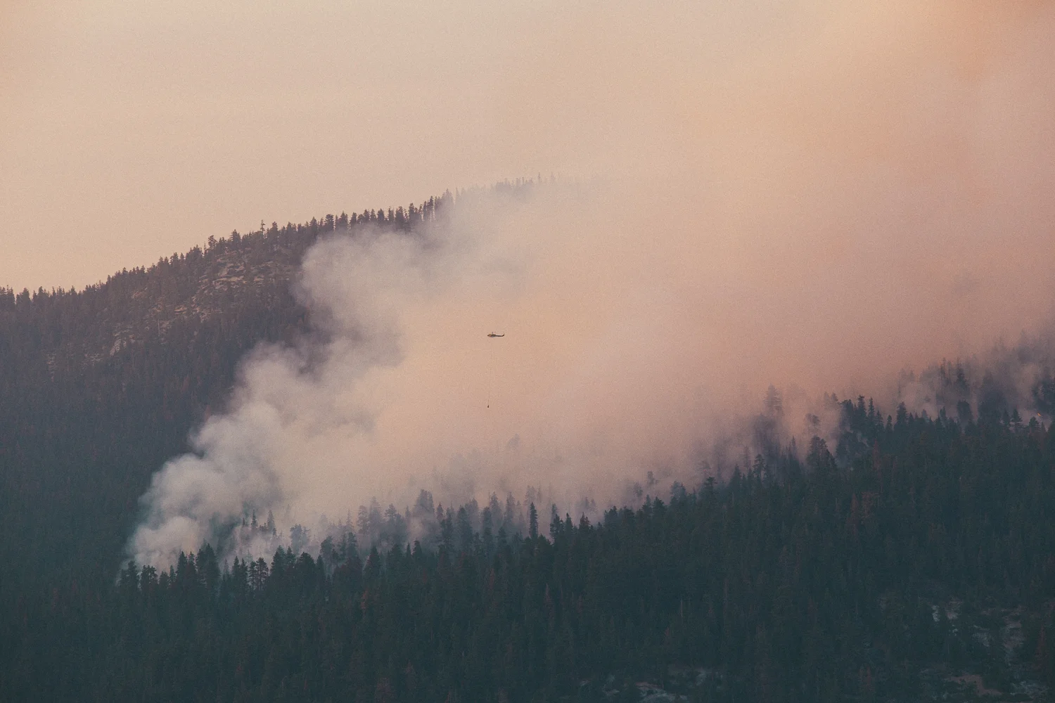 By the time I made it up the hill, the fire had already spread hundreds of acres. Firefighting crews were already on it, dropping flame retardant from air tankers and huge buckets of water from their helicopters. Somebody hadn't been listening to ole Smokey The Bear.