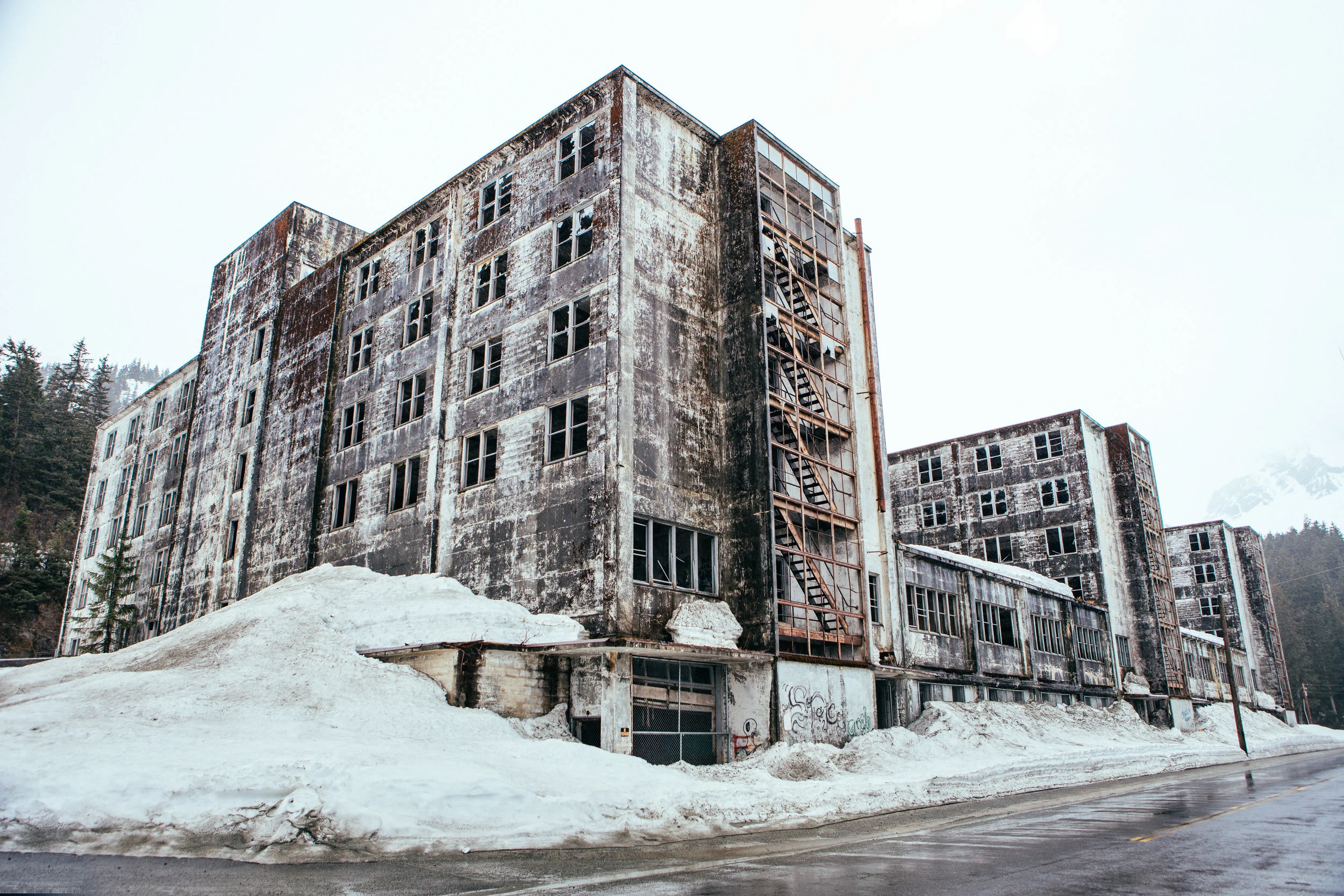 Once upon a time this place use to house everybody in the entire town and had all the stores, school, hospital, and everything, basically to make it a "city under one roof" since the weather gets so bad here. After the great Alaska Earthquake, they built a new one and let this place become a zombie den.