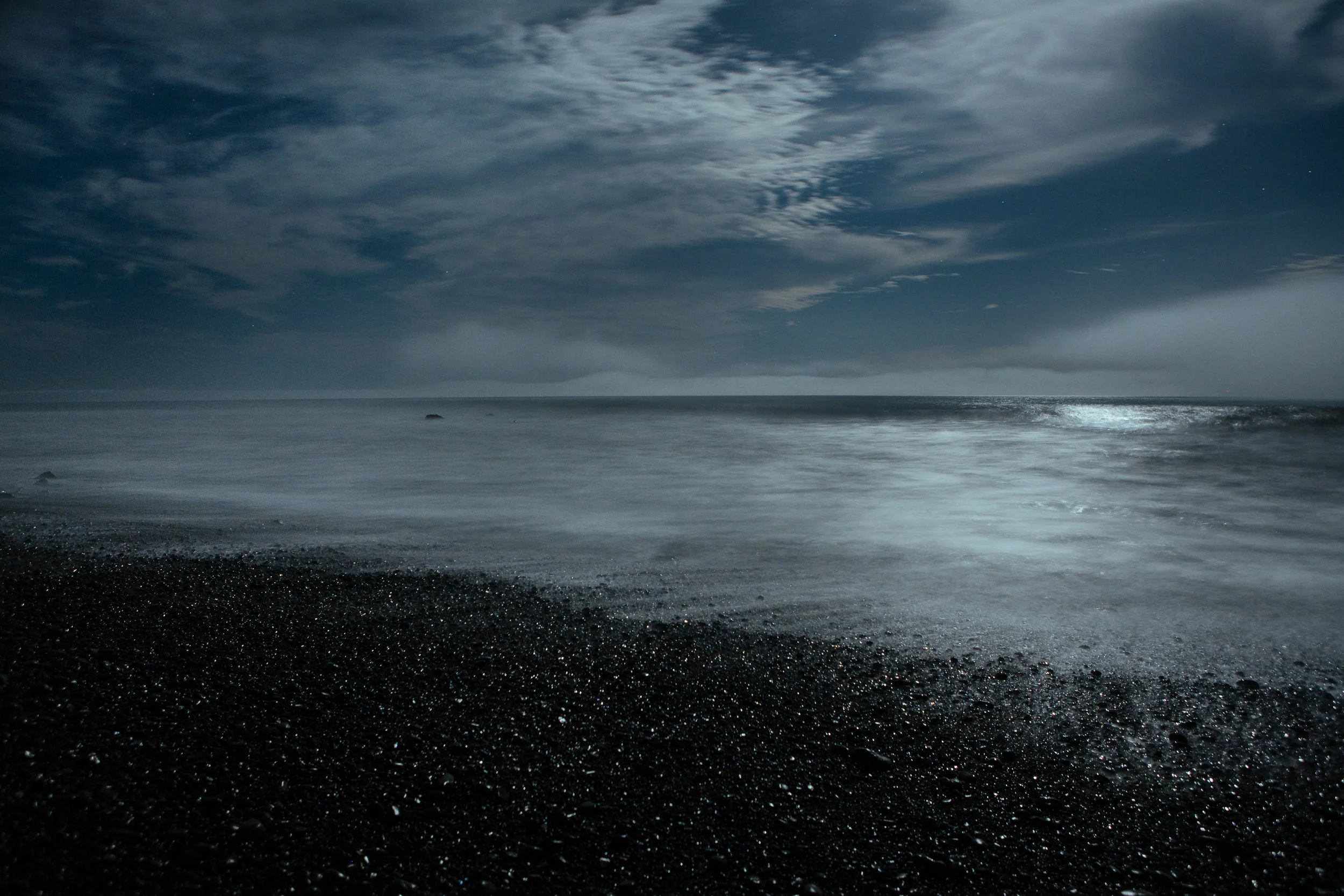 Black marble ocean at midnight.