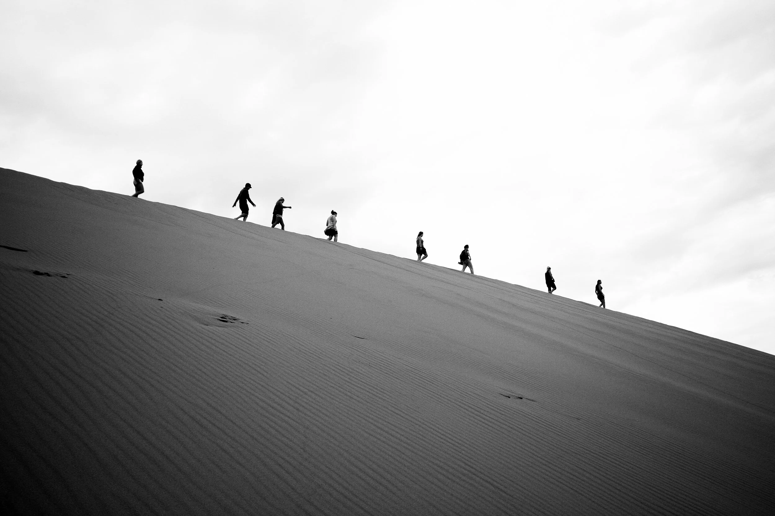 Walking down one of the immense sand dunes in Sossusvlei, Namibia.