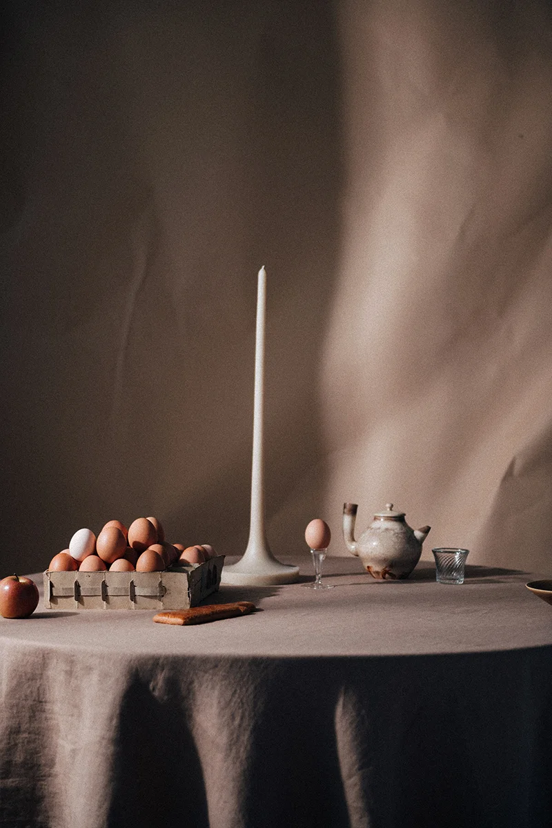 Still life photograph for In Bed Linen editorial studio featuring fruit and pottery on a tabletop