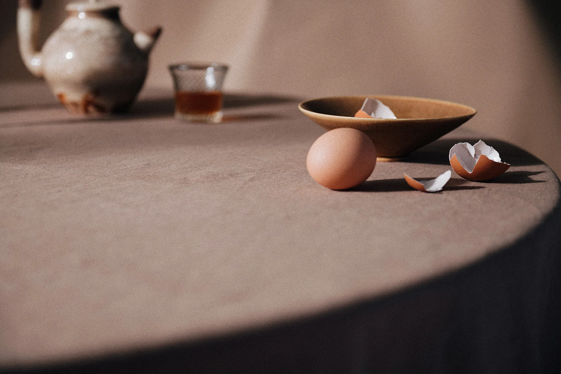 Still life photograph for In Bed Linen editorial studio featuring fruit and pottery on a tabletop