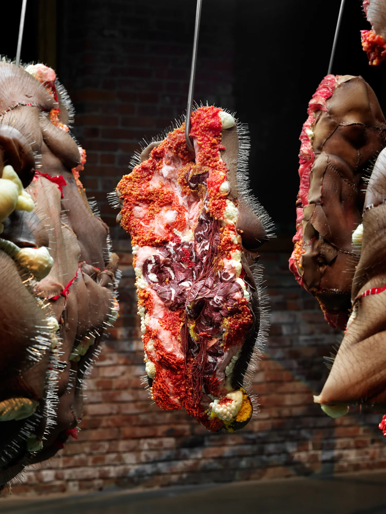 Rack of those Ravaged and Unconsenting Silicone, Insulation foam, Glass beads, Fiber Glass insulation, Steel meat hooks, Steel pins, Pearls, 8'x8'x8' 2017